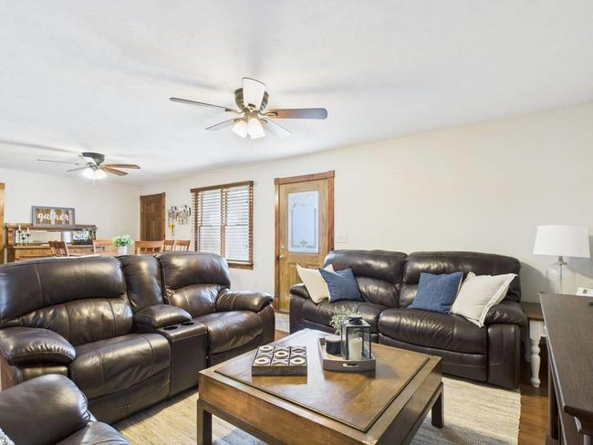 Living room featuring wood trim, flooring and ceiling fan | Image 18