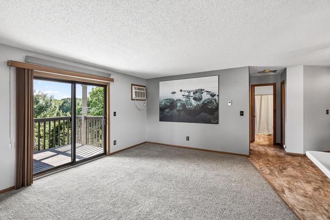There is a fantastic deck just off the living room which offers wooded views. It is a perfect location to relax and unwind in the warmer months. You could also grow a container garden here. | Image 7
