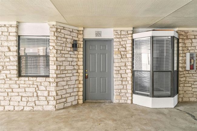 View of exterior entry with stone siding | Image 7