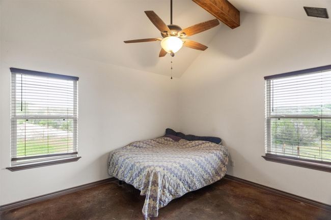 Primary bedroom, multiple windows, and vaulted ceiling with beams | Image 5