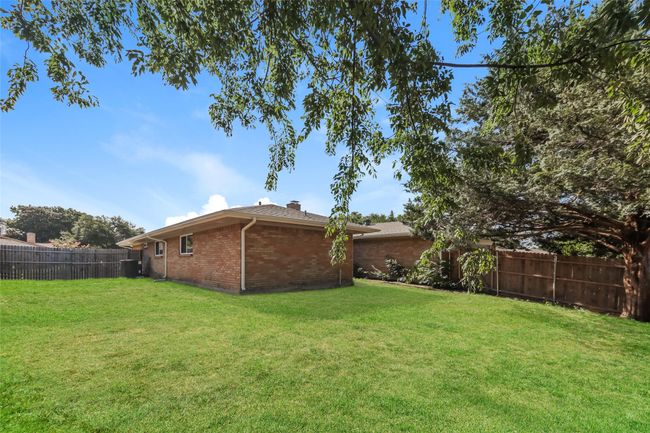 View of fenced backyard | Image 25