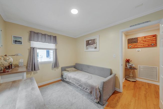 Sitting room featuring baseboards, ornamental molding, light wood finished floors, and visible vents | Image 33