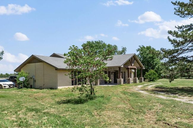 View of front facade featuring brick siding and a front yard | Image 6