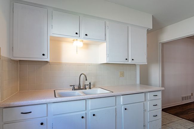 1214 Hunt - Kitchen featuring light countertops, a sink, tasteful backsplash | Image 6
