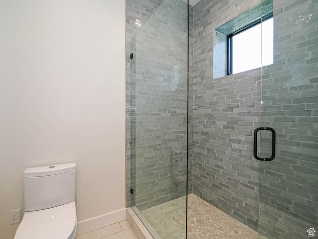 Bathroom featuring a stall shower and tile patterned flooring | Image 85