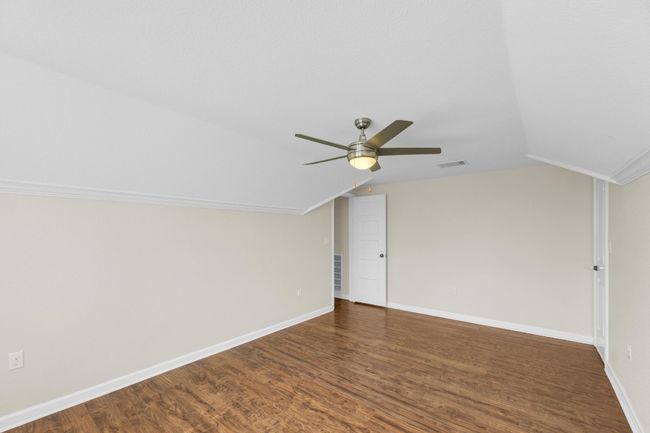 Additional living space with wood finished floors, lofted ceiling, and a ceiling fan | Image 32