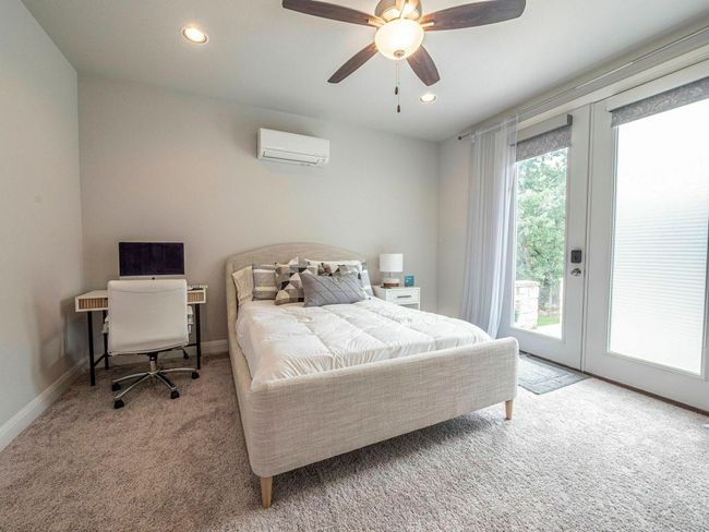 Bedroom with a wall mounted AC, carpet, access to outside, french doors, and recessed lighting | Image 21