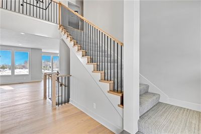 Stairs featuring hardwood / wood-style flooring and a towering ceiling | Image 2