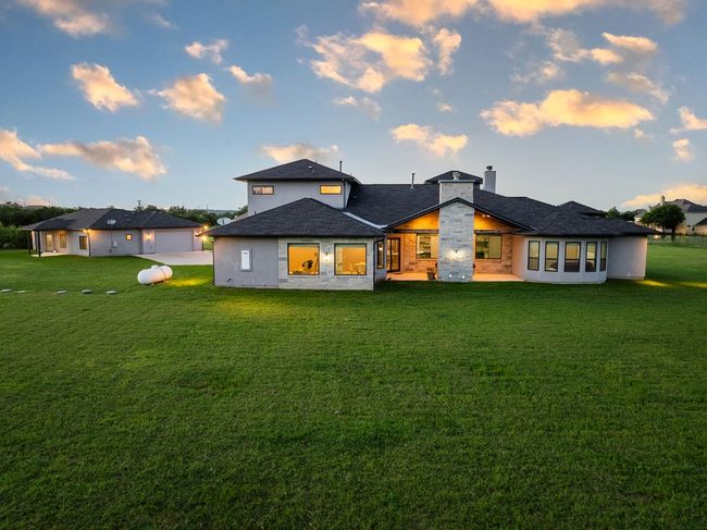 Rear view of property with a lawn, a chimney, and a garage | Image 27