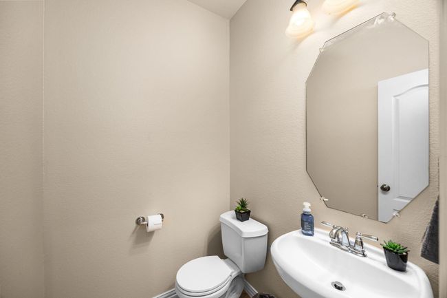 The half bath located on the landing on the stairs. | Image 8