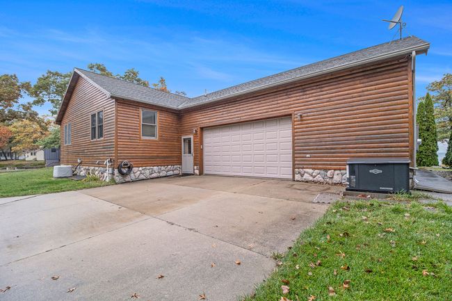 Rear side of home with parking. | Image 42