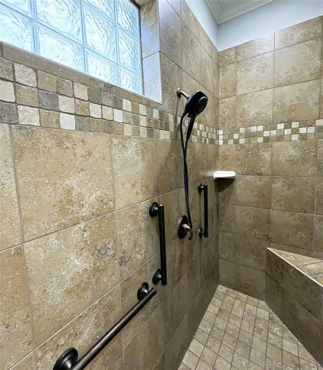 Primary bath shower with a stylish tile bench seat. | Image 21