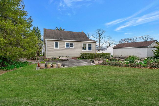 Rear view of property with an outbuilding, a patio area, and a lawn | Image 9