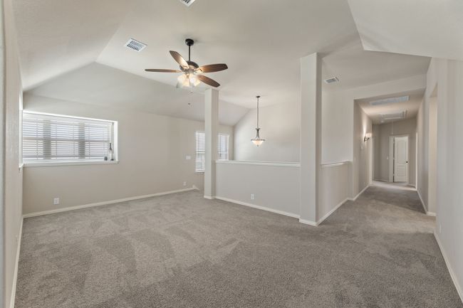 game room loft with carpet floors, ceiling fan, and vaulted ceiling | Image 25