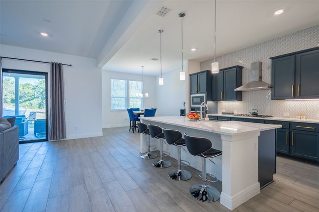 A look at both the bright kitchen and the sun-filled breakfast area. | Image 10