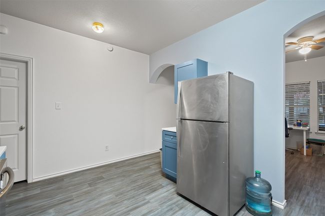 The heart of the home is a beautiful kitchen with wrap around counters, custom cabinet color, electric stove, microwave, and recent refrigerator with is included. | Image 8