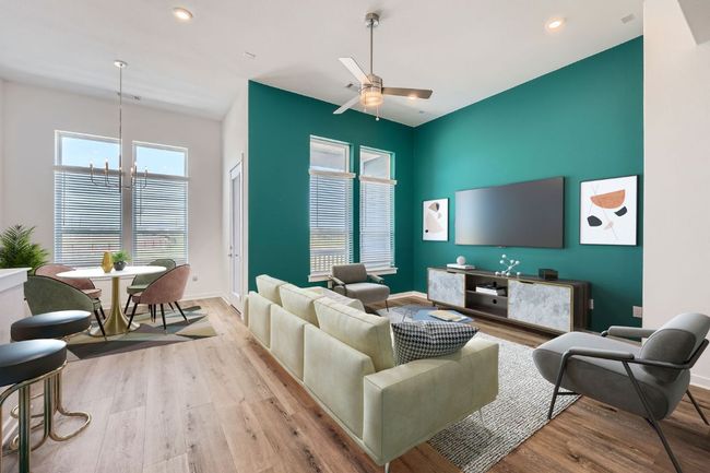 Living room featuring baseboards, recessed lighting, wood finished floors, and ceiling fan with notable chandelier | Image 6