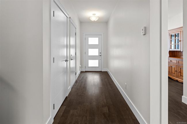 Doorway to outside with dark wood-style floors and baseboards | Image 5