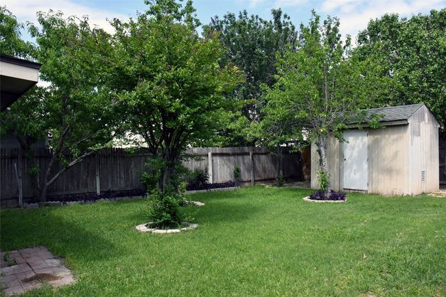 View of yard with a fenced backyard, an outdoor structure, and a shed | Image 30