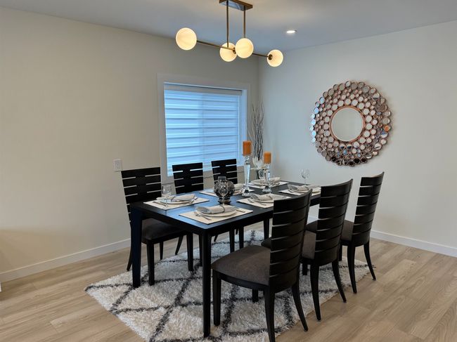 Dining room with light wood-style flooring and recessed lighting | Image 22