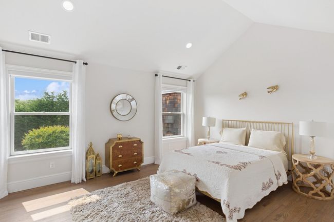 Bedroom with lofted ceiling, wood finished floors, recessed lighting, and baseboards | Image 18