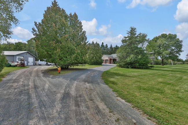 Approach to the circle drive to pole building and home. | Image 7