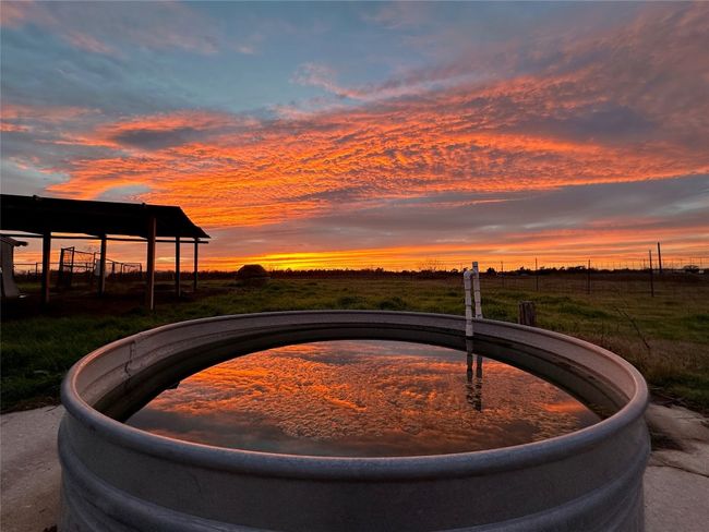 No filter! Sunset view of barn area - sunset reflection off the stock tank. | Image 40