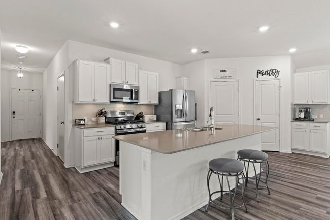 Upgraded luxury vinyl plank flooring runs throughout all common areas. | Image 5