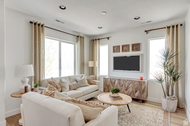 Living area with healthy amount of natural light, light wood-type flooring, and recessed lighting | Image 36
