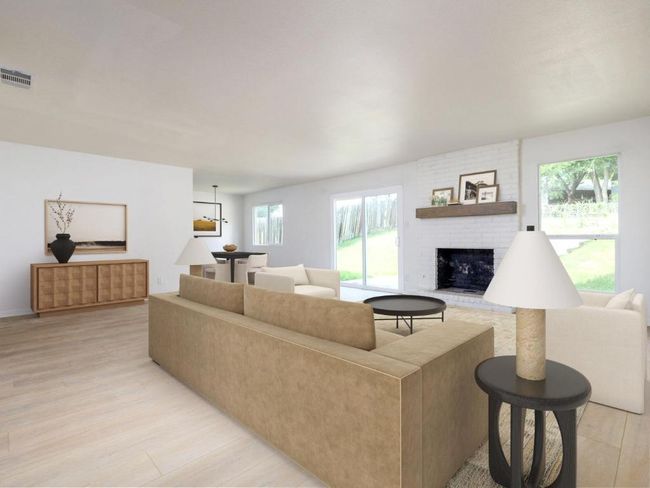 Living room with a fireplace and light wood-type flooring | Image 4