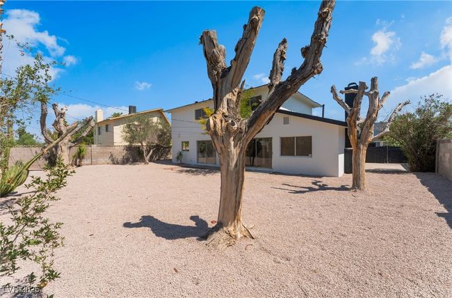 Back of property featuring a fenced backyard and stucco siding | Image 54