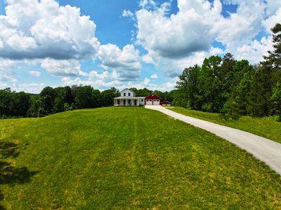 Nestled in the serene landscapes of Kentucky, this 18-acre property offers the perfect blend of rustic charm and modern luxury! | Image 1