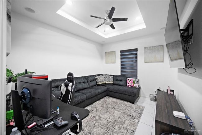 Living area with ceiling fan, a raised ceiling, and recessed lighting | Image 24