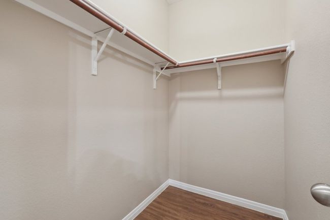 Walk in closet with dark wood-type flooring | Image 21