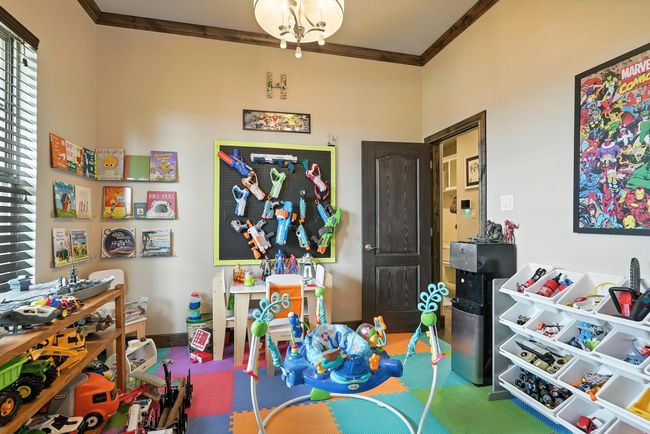 Rec room featuring ornamental molding and baseboards | Image 11