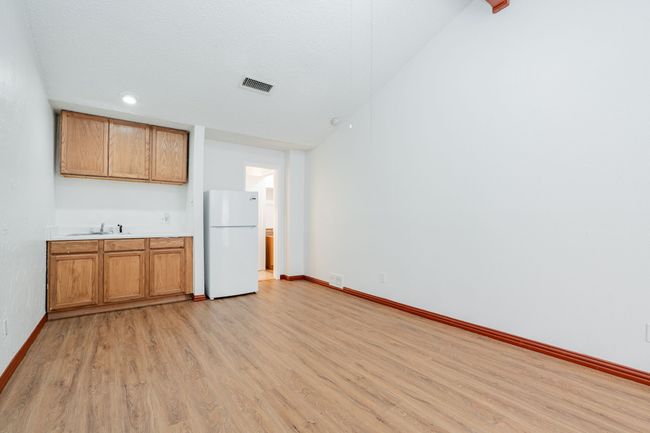 Kitchen with baseboards, light countertops, freestanding refrigerator, and light wood-style floors | Image 17
