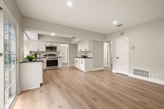 The flooring is light-toned wood, which gives a warm and updated feel. | Image 15