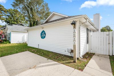 View of property exterior with a lawn and a patio area | Image 3