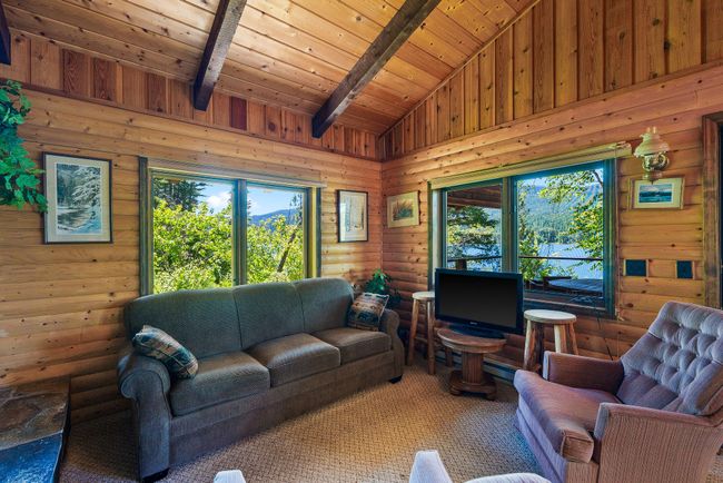 Living area featuring wooden ceiling and walls with a carpet flooring | Image 13