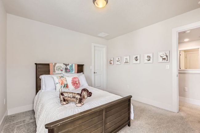 Bedroom with light carpet and baseboards | Image 20