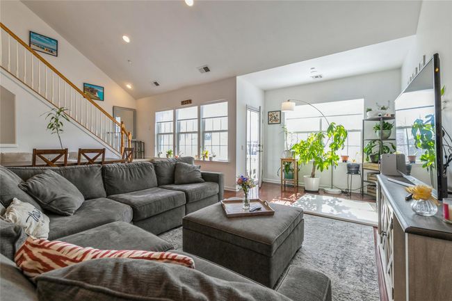 Living area featuring recessed lighting, stairway, visible vents, high vaulted ceiling, and wood finished floors | Image 4