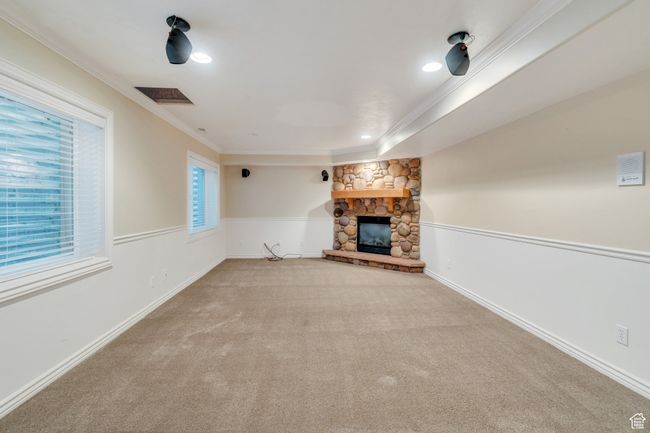 Unfurnished living room featuring crown molding, a fireplace, carpet floors, and recessed lighting | Image 21