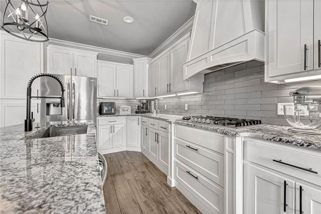 Modern kitchen with gas cooktop. | Image 5