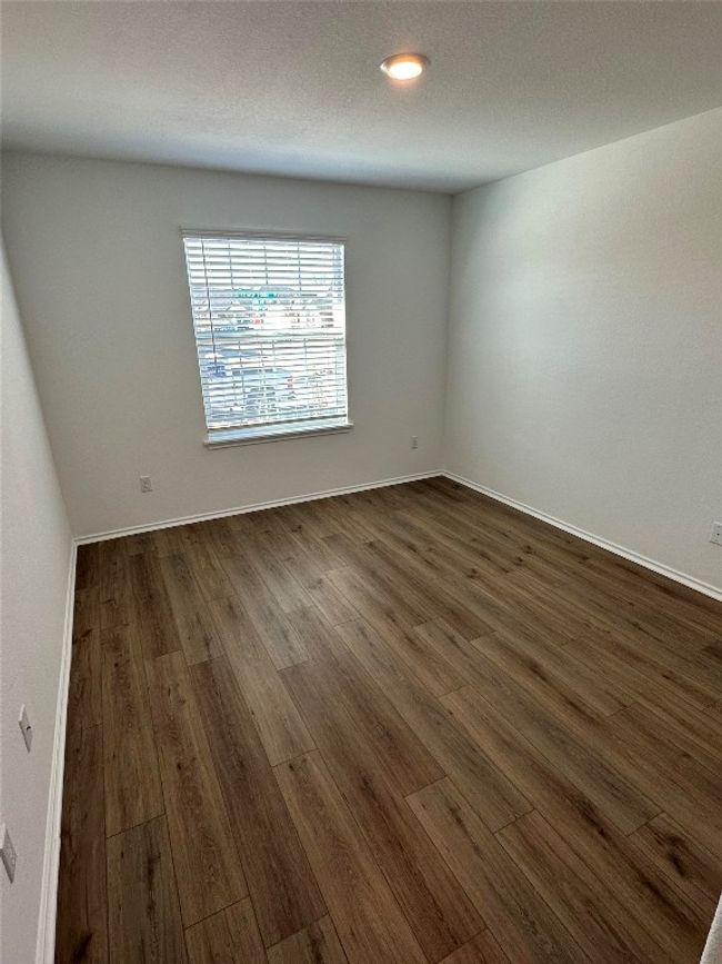 Spare room with dark wood-style flooring and baseboards | Image 17