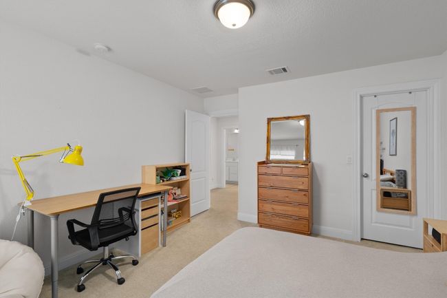 Carpeted bedroom featuring a desk and baseboards | Image 23