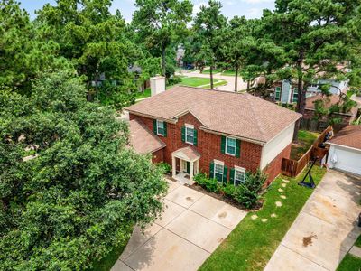 Amazing aerial shot of this gorgeous home situated on a quiet street in the sought after community of Copperfield Southcreek Village zoned to Cypress-Fairbanks ISD. Lush landscaping, well manicured front lawn and a wonderful backyard perfect for an outdoor sitting area. | Image 2