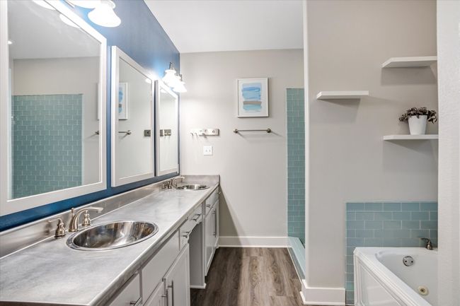 Bathroom featuring wood-type flooring, vanity, and shower with separate bathtub | Image 12