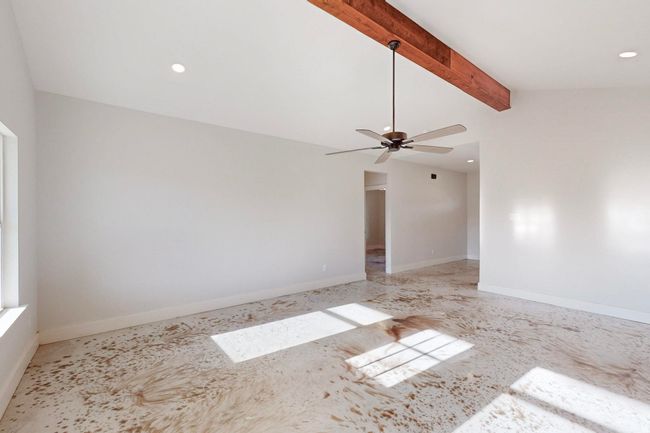 Unfurnished room with vaulted ceiling with beams, baseboards, a ceiling fan, and recessed lighting | Image 10