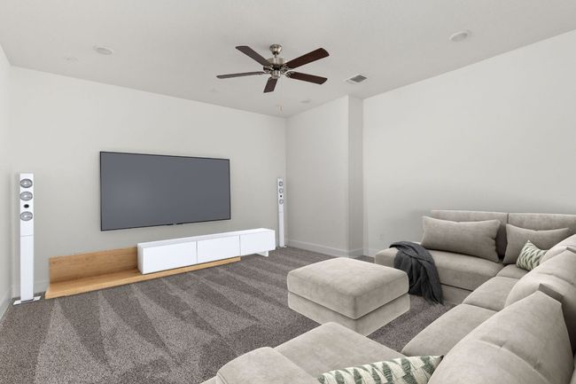 Media room with carpet, ceiling fan, and baseboards | Image 5