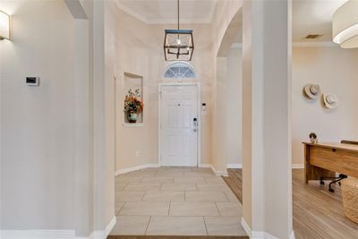 Entryway featuring light wood-type flooring and ornamental molding | Image 3